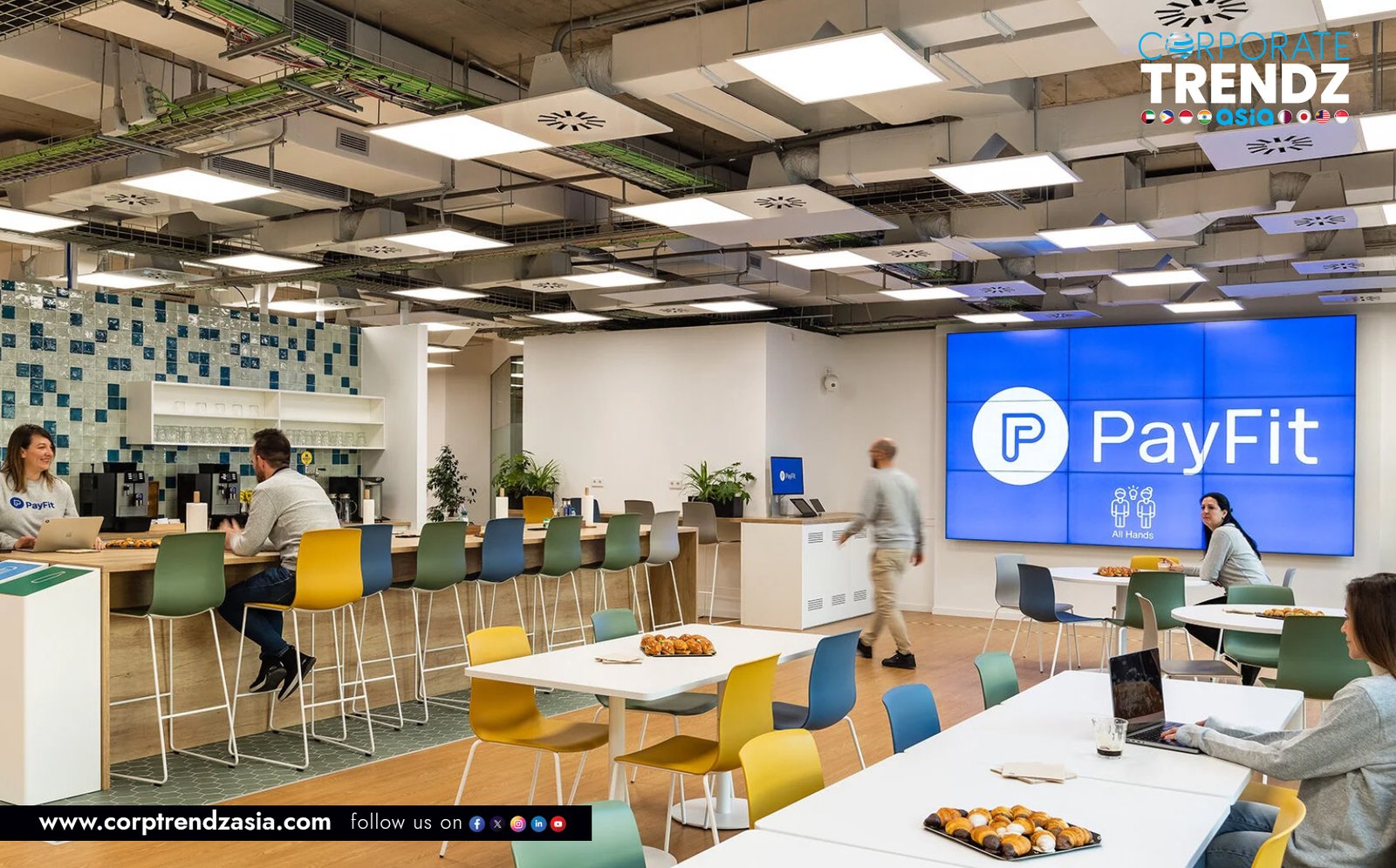 A smiling SME manager using the PayFit HR platform on a laptop to easily manage employee payroll and leave requests.